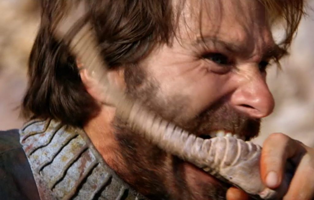 The human chews on the Sand Slug Creature!