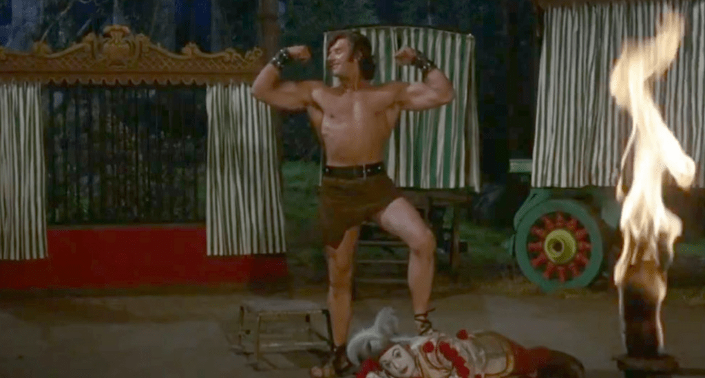 Dave Prowse flexes his muscles