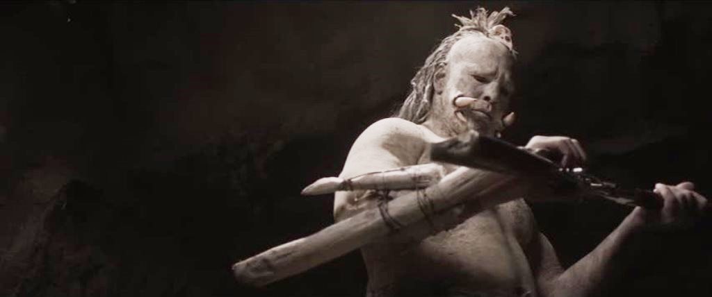 A cannibal inspects a rifle