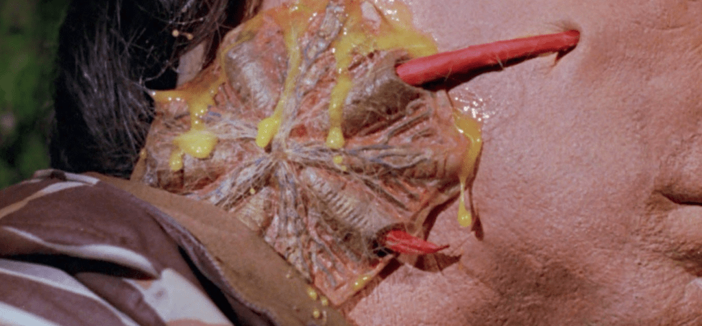 Red tendrils sink into a victim's face