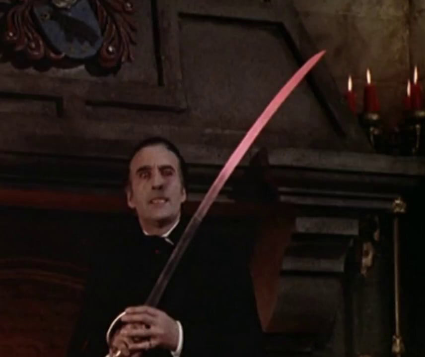Dracula brandishes the red-hot sword