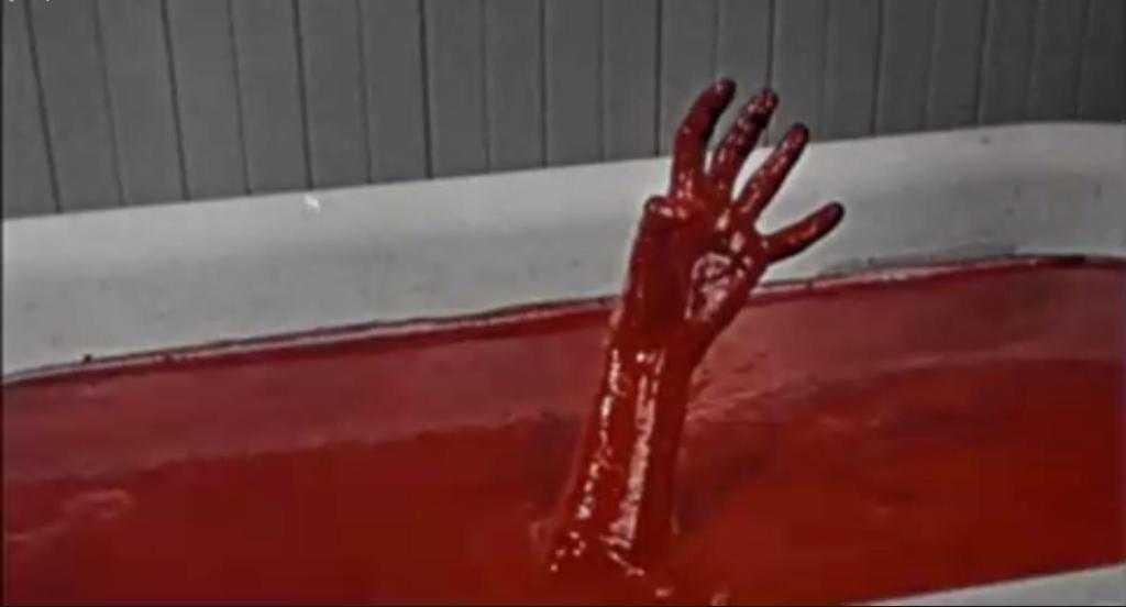 A bloody hand rises from the bathtub...