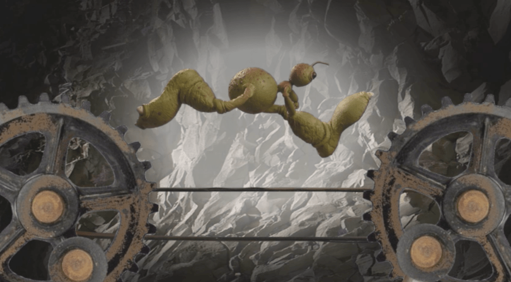 A Selenite with big legs & feet runs on a treadmill that helps to power the subterranean world