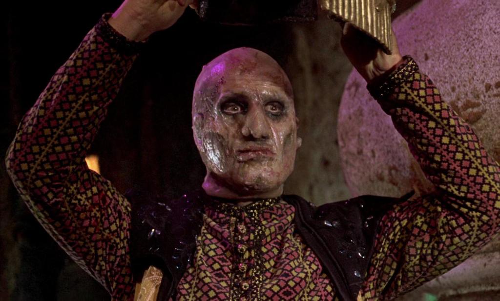 The Vizier reveals his scarred face to act as a distraction, so that Sinbad can escape the green men.