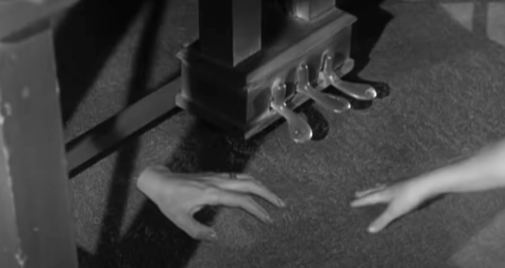 The ghostly hand crawls across the carpet