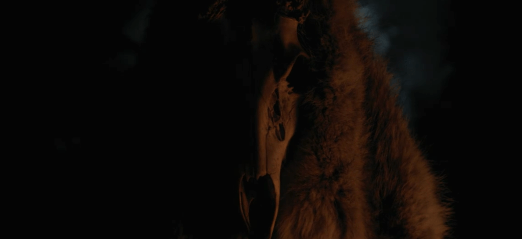 Deer skull-wearing character seen close-up