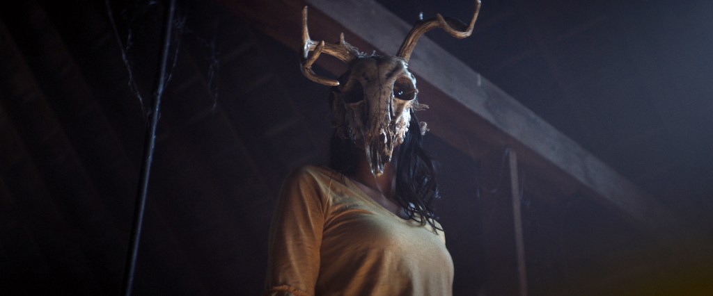 The witch, in Sara's body, wears a stag skull