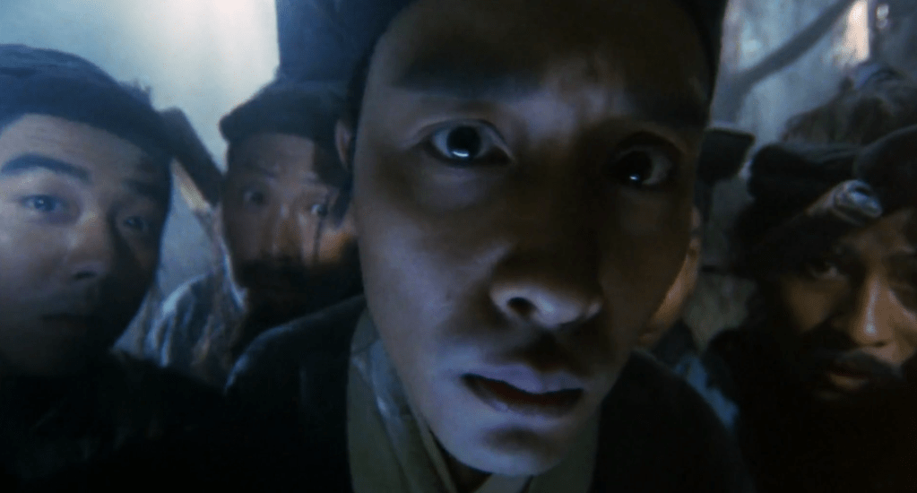 Leslie Cheung looks closely at a monster...