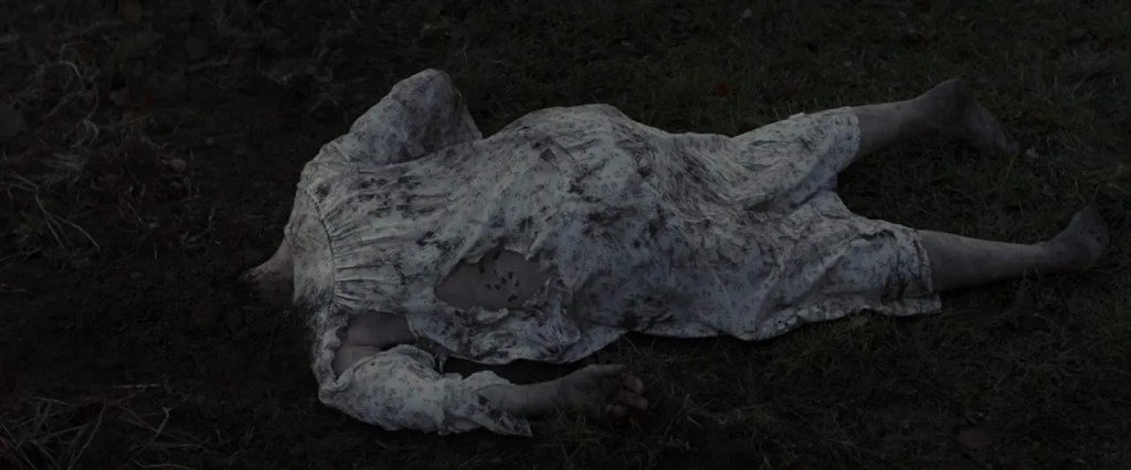 Noreen's corpse lies with her head beneath the soil