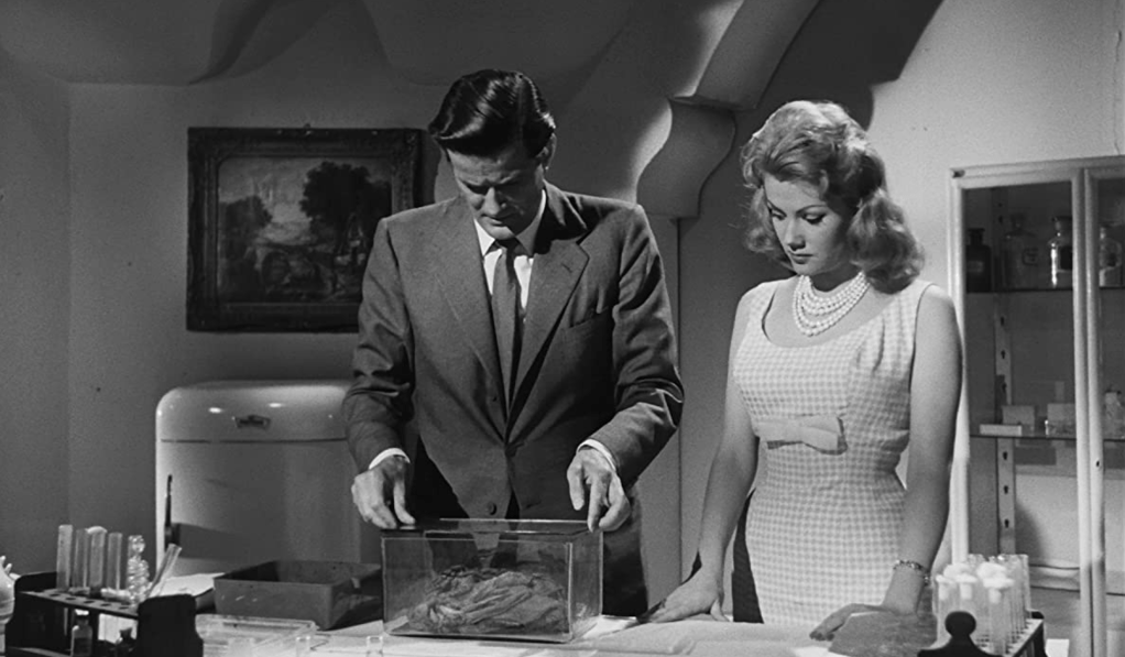 The hero (John Merivale) and his wife (Didi Sullivan) should never have taken the surviving piece of Caltiki back to their home...