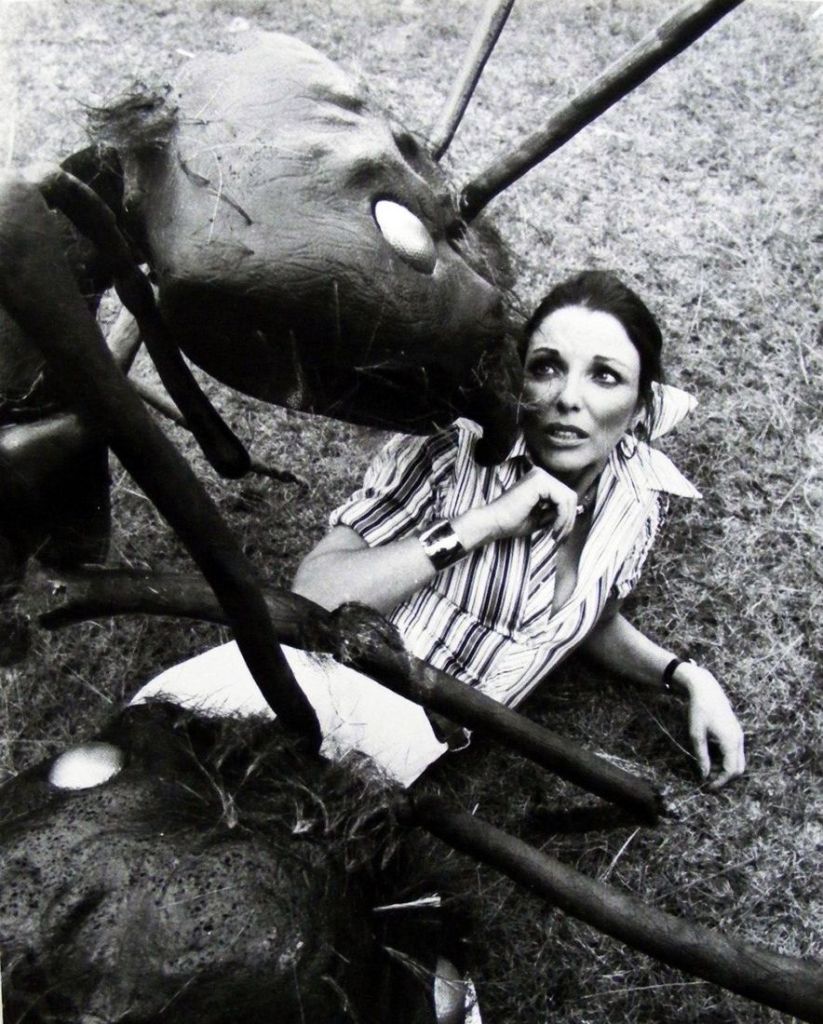 Publicity shot of Joan posing with a couple of the giant ant props