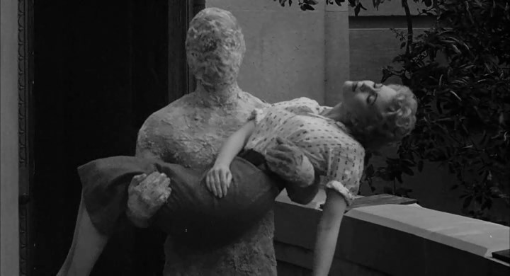 The Faceless Man carries off the girl. Well, of course he does!