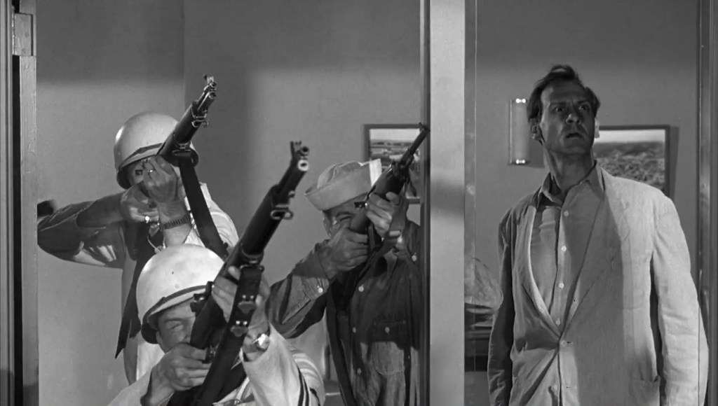 Dr. Jess Rogers looks on as armed personnel prepare to blast the beast