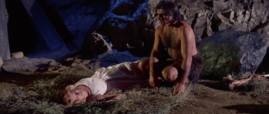 The caveman takes Betty to a cave, where he makes her cook for him