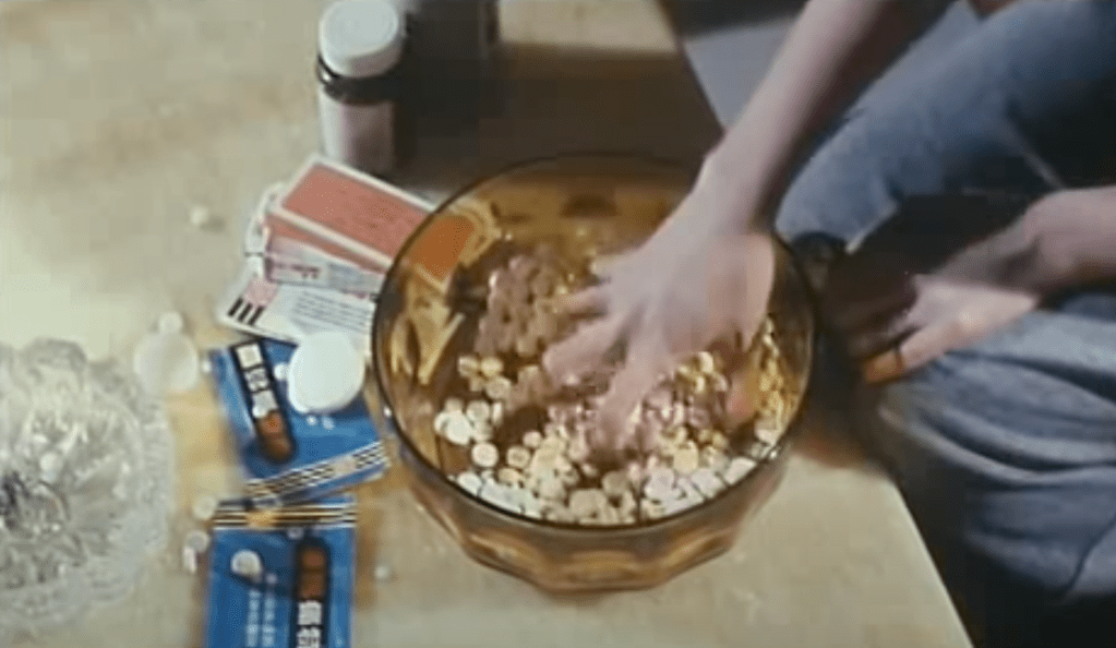 Annie grabs a handful of pills