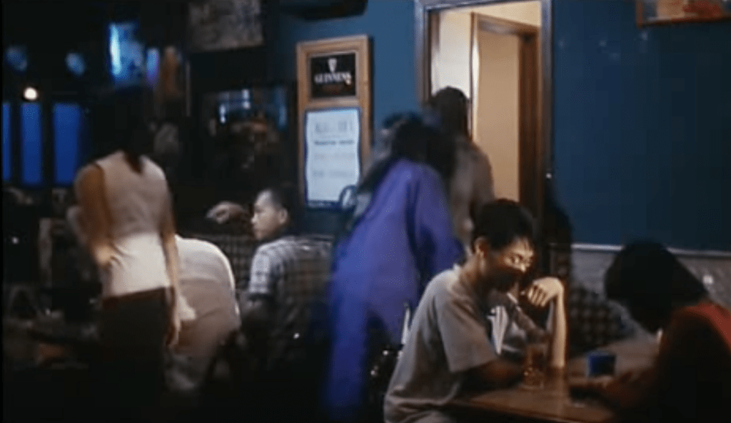 The blue-robed ghost closely follows a female character into a bar toilet