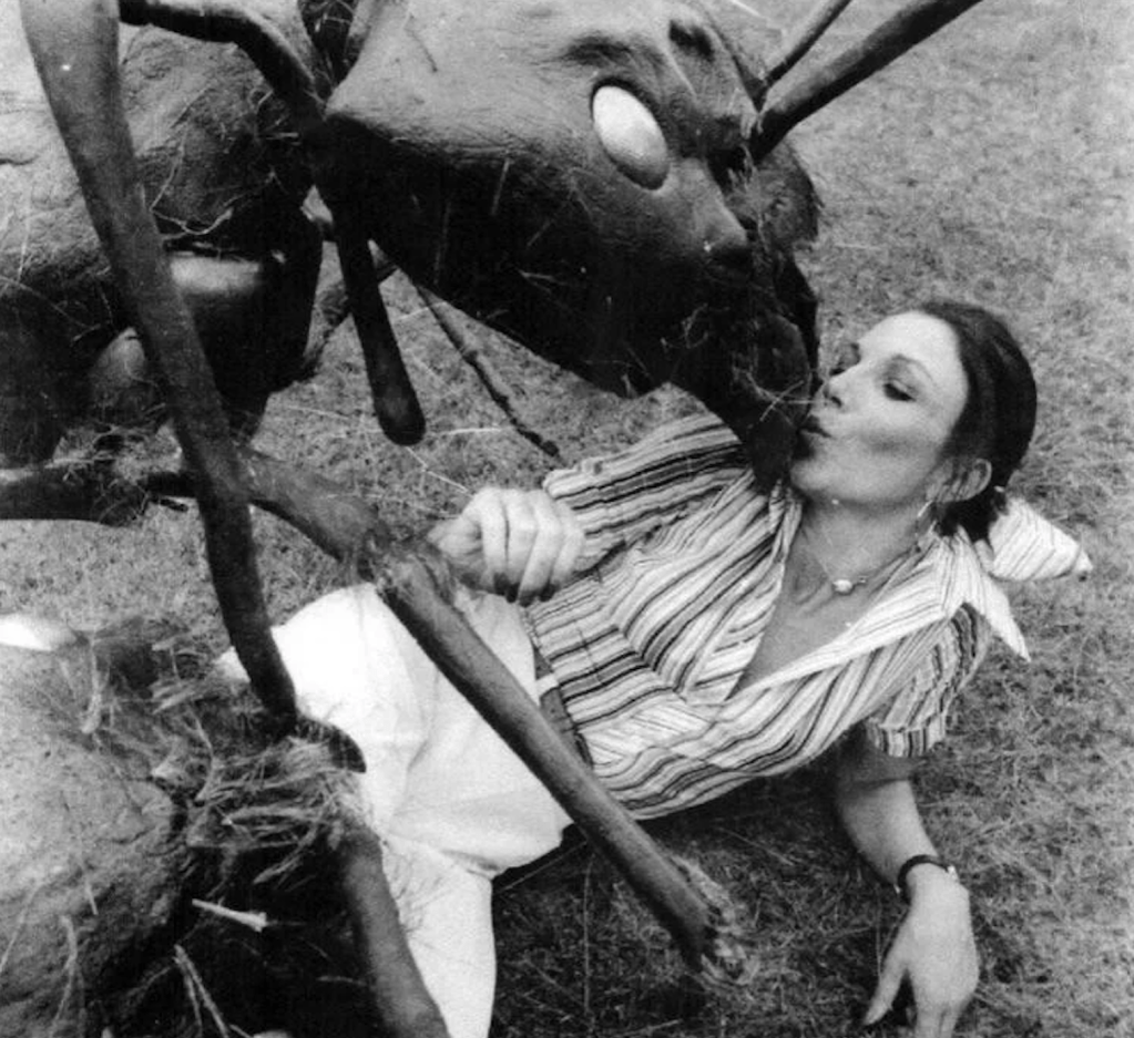 Joan doesn't seem to mind being in the company of a huge insect in this publicity still!