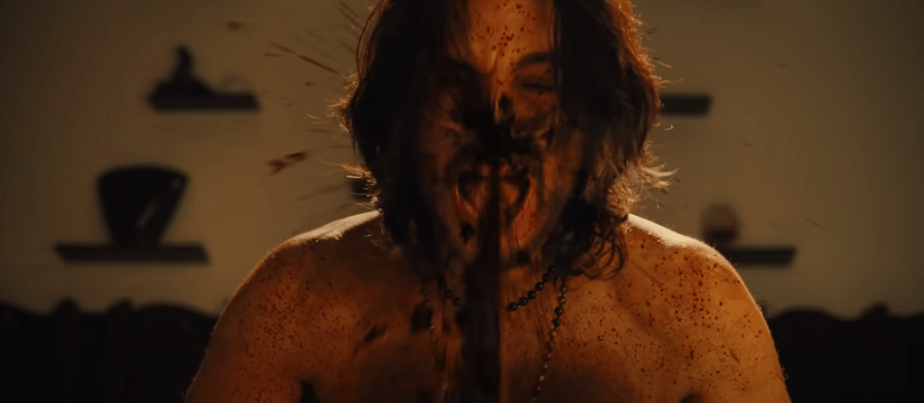 ...and the saw chews into Rami's face...