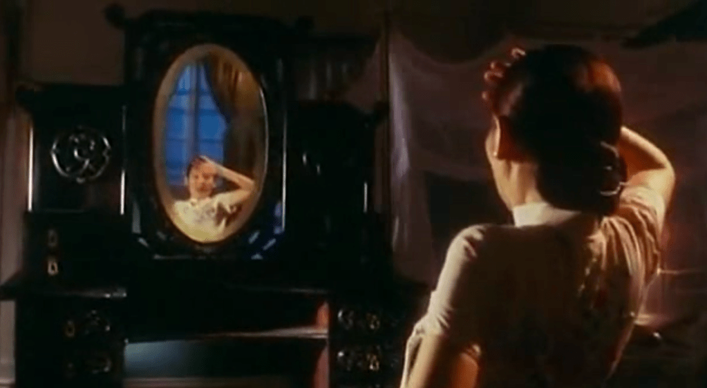 The dressing table moves towards Mary. If only it had creepily slid around the place more often in the movie!