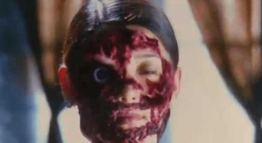 Mary peers into the mirror and her face appears to be messed-up in the reflection