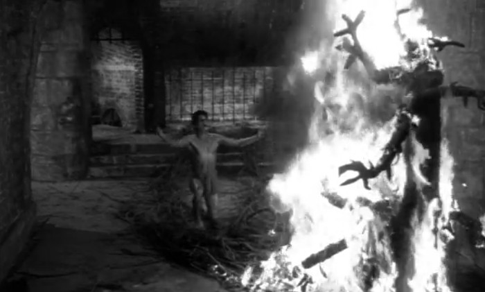 Tanga prays to his beloved tree monster as it burns