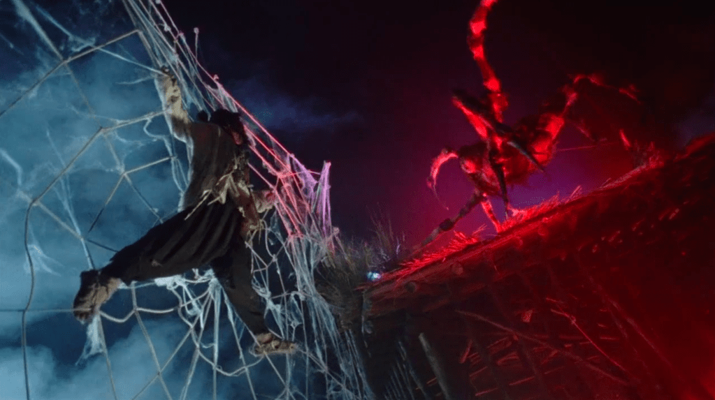 ...and the arachnid-monster closes-in across a roof!