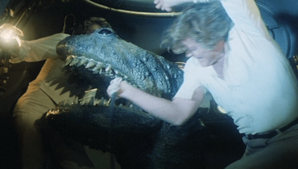 ...but the plesiosaur-beast works better as a full-scale monster when it pokes its head inside the diving bell