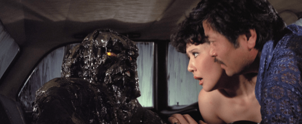 The Oily Maniac seeks revenge on Sheng's shady boss as he canoodles with his secretary in a car