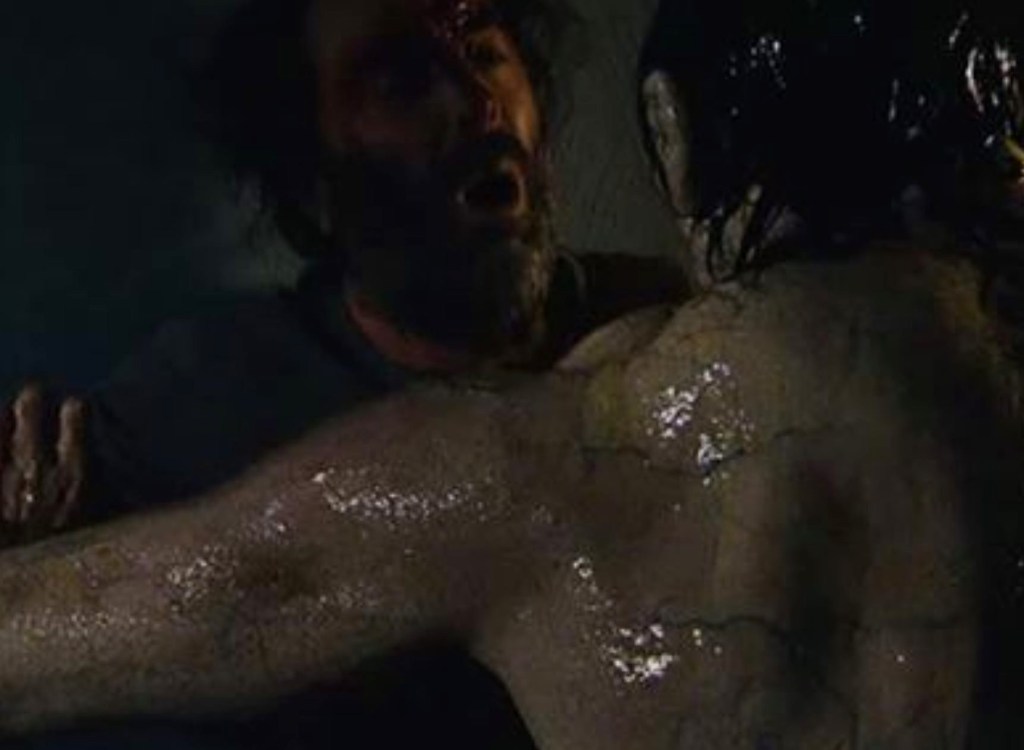 Cathal is assaulted by the man-monster, which has pale, moist, veined skin