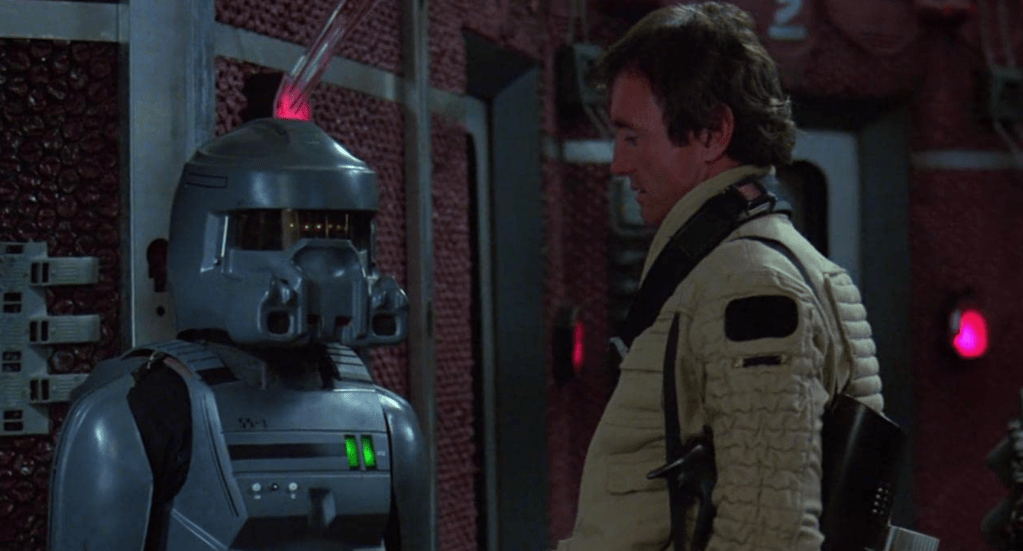 SAM-104 (Don Olivera) and Mike Colby (Jesse Vint)