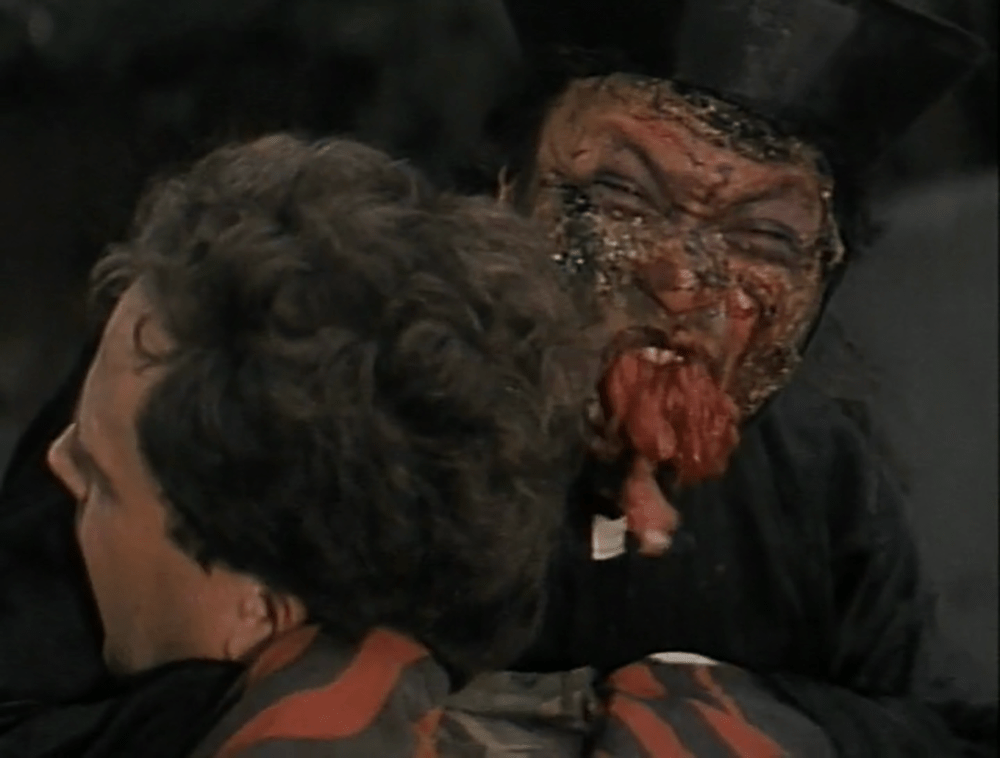 A scab-faced vampire with a mouthful of his victim's flesh!