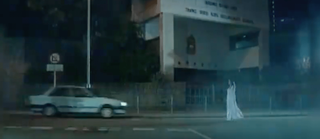 The protagonist drives towards the ghost...