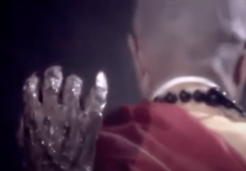 A monster hand reaches up to grab a buddhist monk...