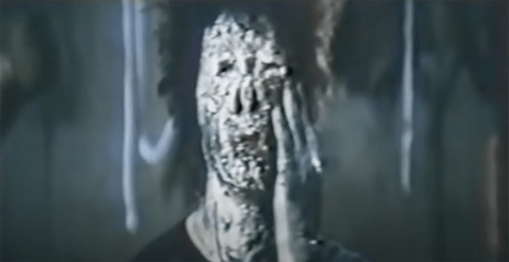 The hopping ghoul prepares to sink its fingers into its own white, lumpy flesh