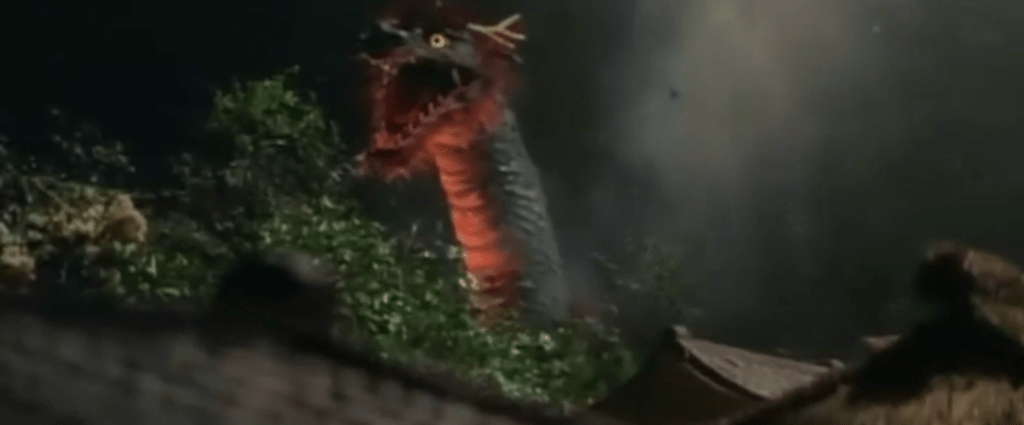 A dragon looms up above a village...