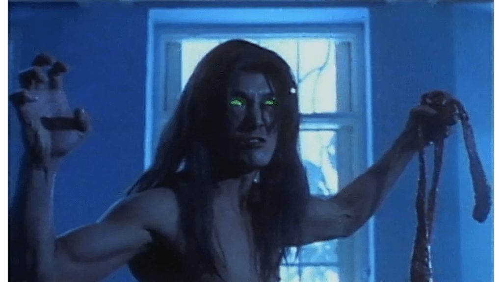 The Moon Monster tears out the mortuary attendant's intestines