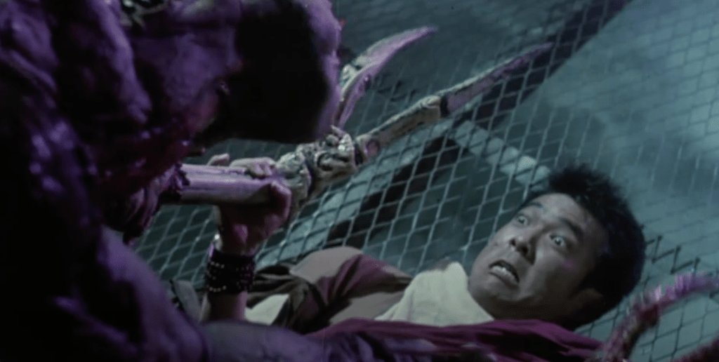 Peacock (Yuen Biao) gets pinned down by the beast!