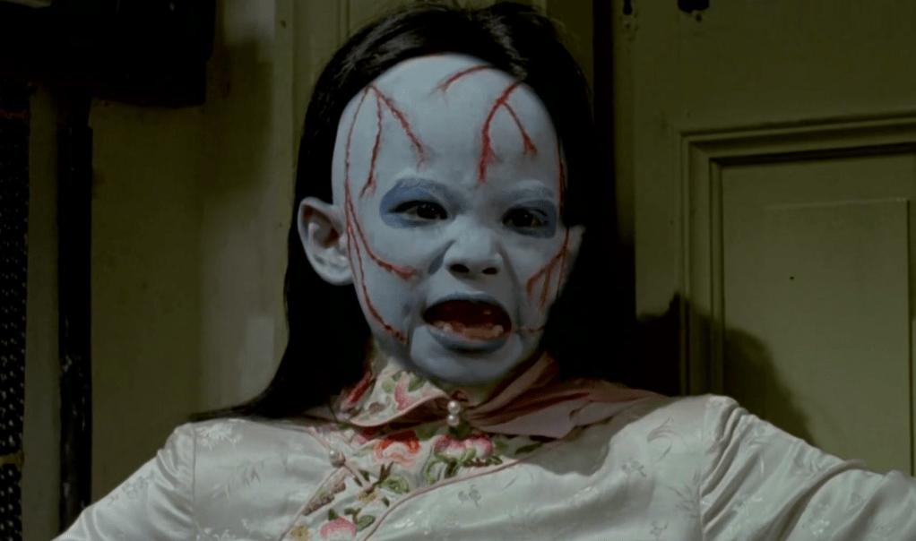 At one point the blue-faced child-spirit's visage is superimposed over the pregnant woman's face