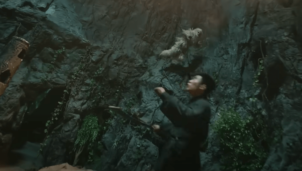 The simian-dude agilely leaps about the rocky walls