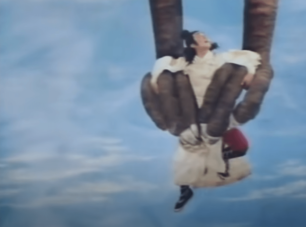 Our hero dangles from the friendly phoenix's claws