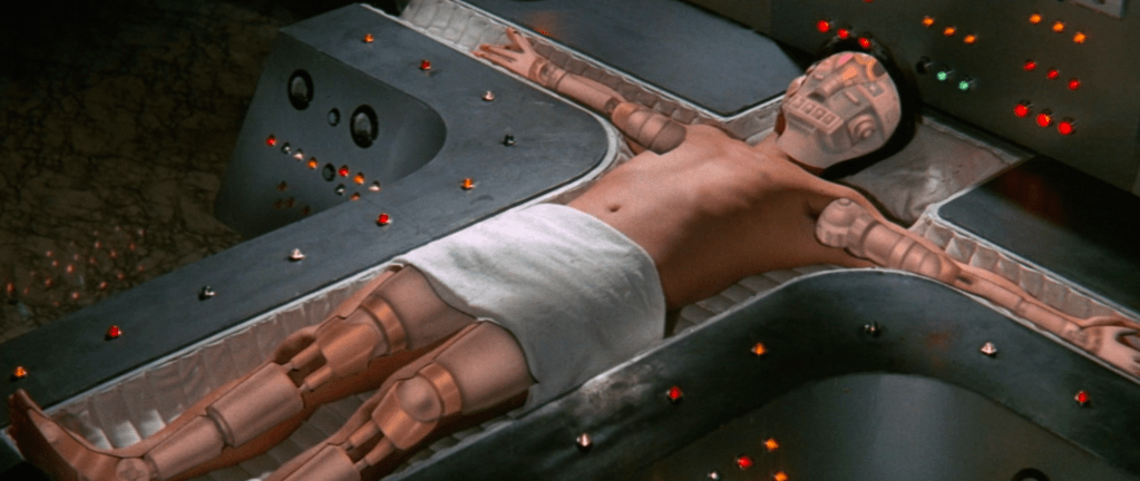 Rayma (Danny Lee) begins to transform on Professor Liu's operating table...