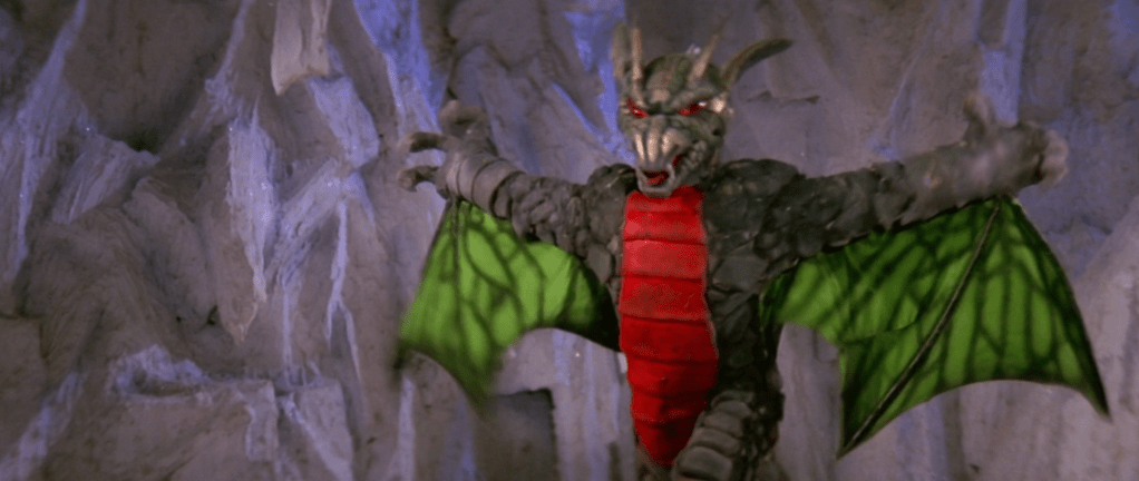 ...so Elzebub turns into her true form: a red-bellied, green-winged dragon-monster!