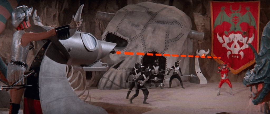 Witch Hands uses a large laser-firing weapon to attack Inframan...