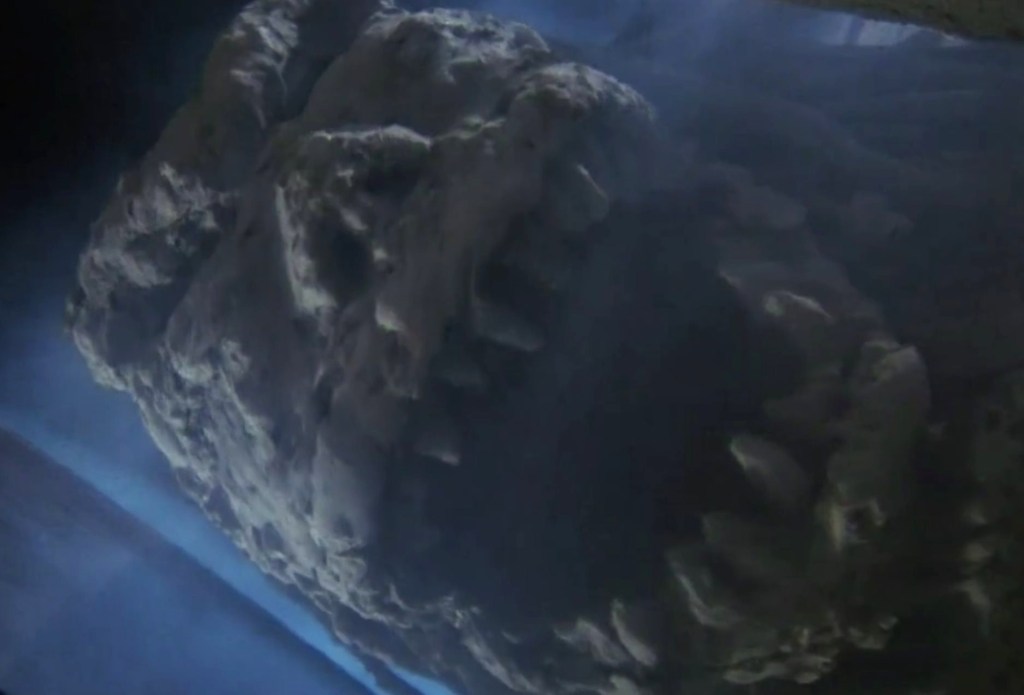 A mountain demon's stony face roars