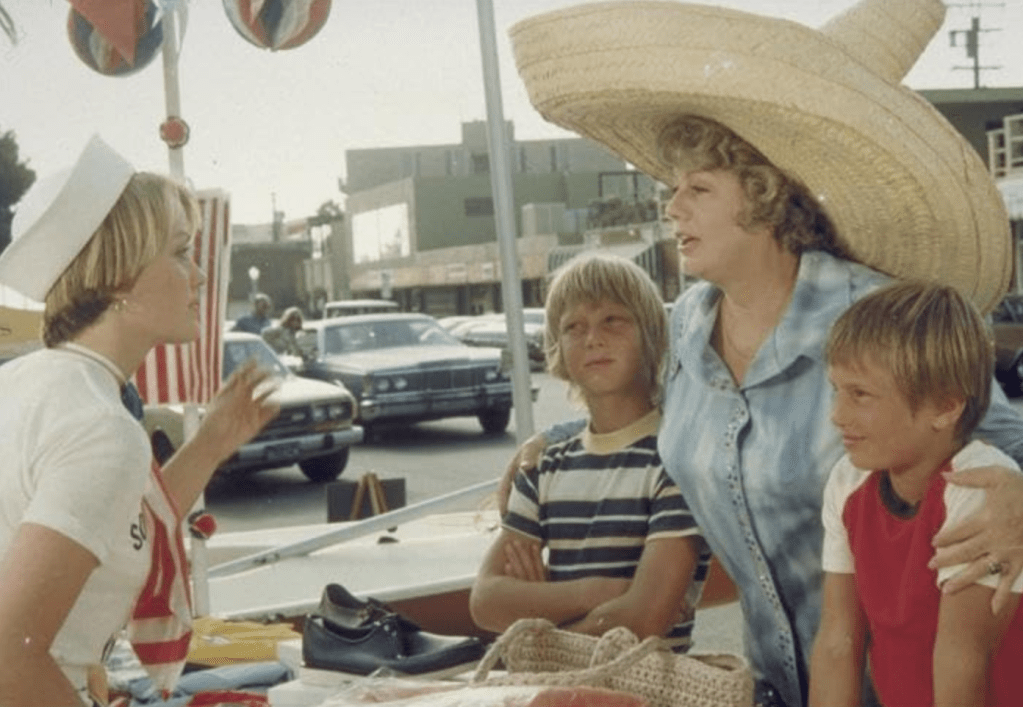 Shelley Winters wears a very large hat