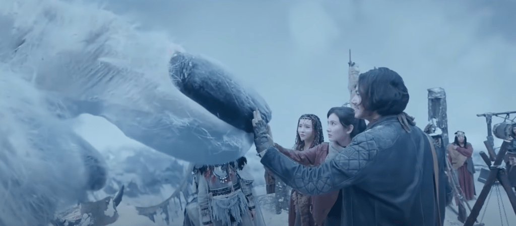 ...and the creature extends a finger for the protagonists to touch...