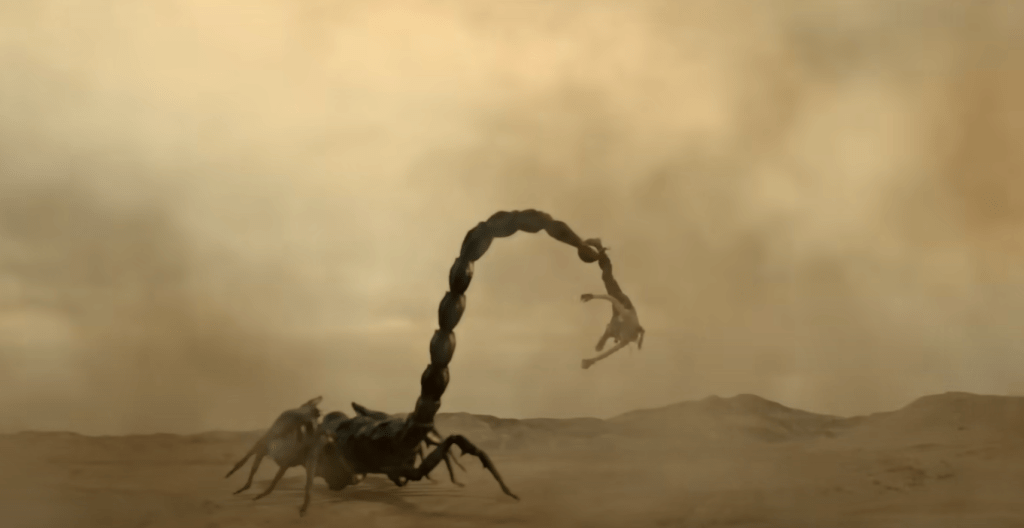 A giant scorpion snags a fighting femme with its stinger