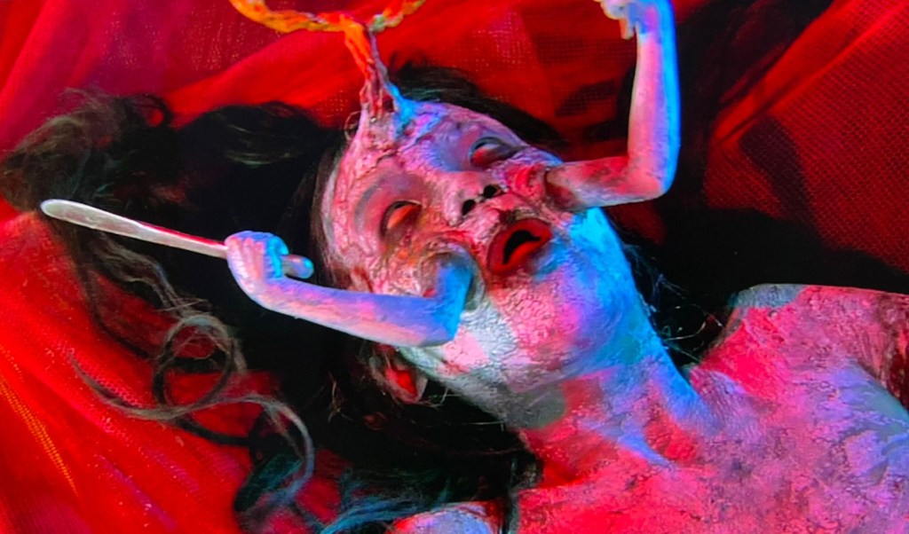 This female zombie has extra ‘child arms’ sticking from her face!