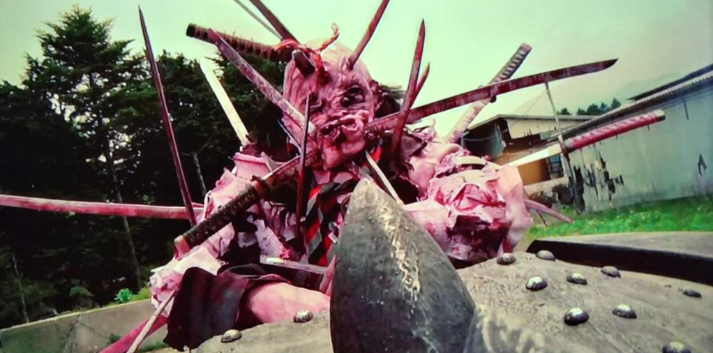 This monstrous zombie has loads of katana blades sticking out of him!