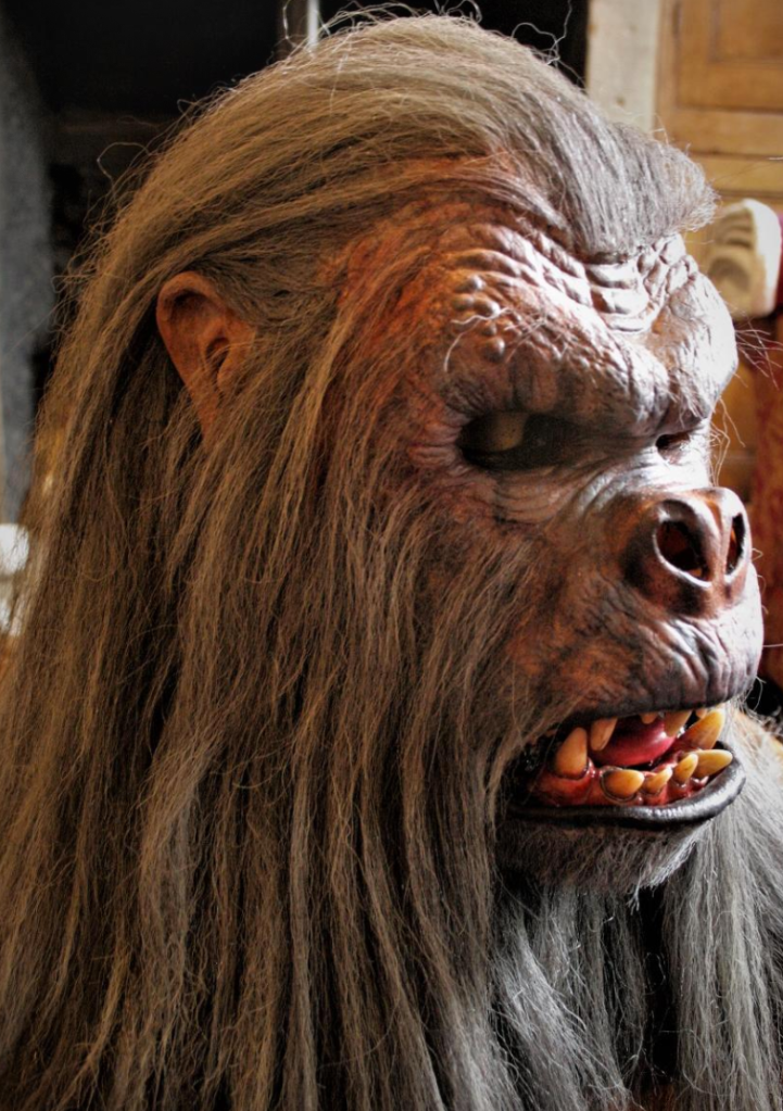 
The man-ape's head with the long, grey hair added